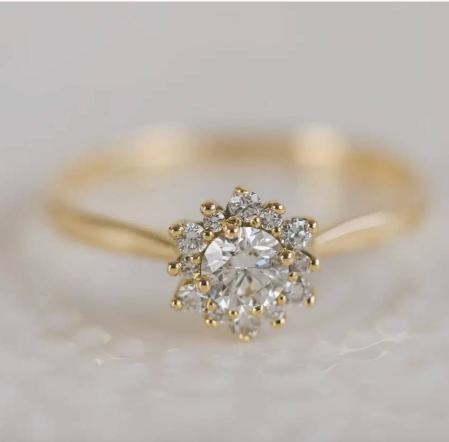 Gold bespoke engagement ring with a sparkling round-cut diamond solitaire on a slim polished band