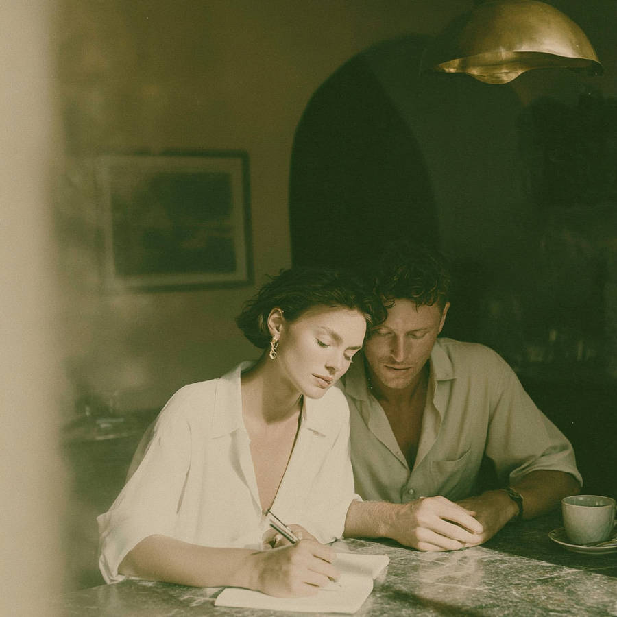a_couple_sitting_at_their_kitchen_table_planning_a_day