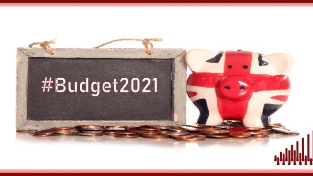 Chalk board reading "#Budget2021" next to a piggy bank in Union Jack colours - The UK public are confused