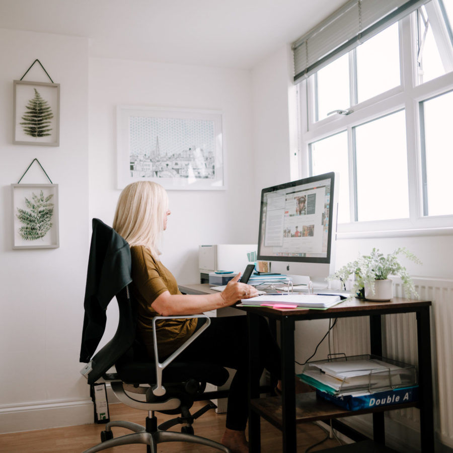 woman sat at a computer, pay and progression
