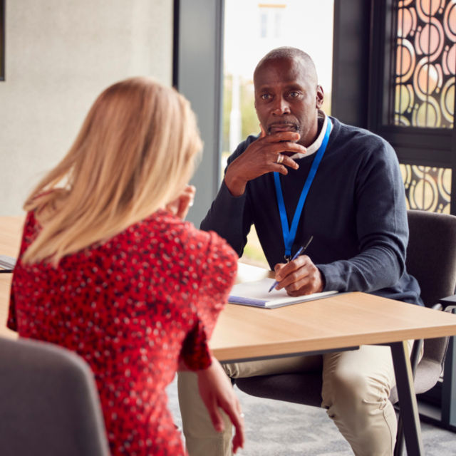Man interviewing a woman - Pay Review Bodies
