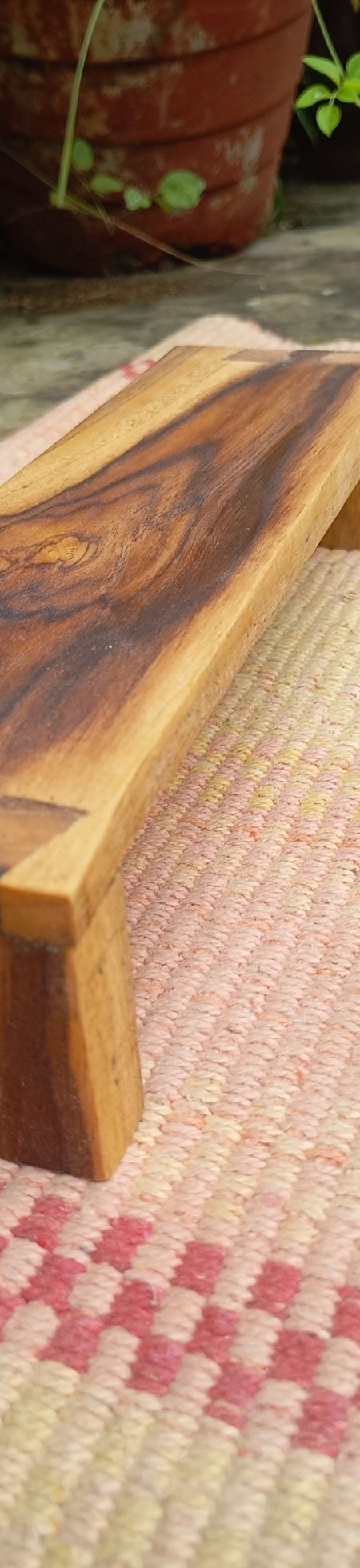 low teakwood bench with dovetail joinery