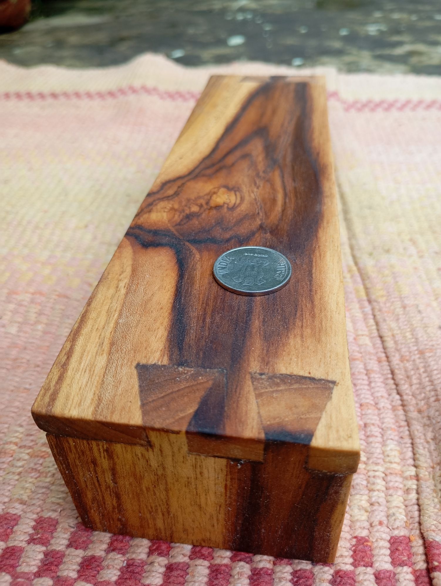 low teakwood bench with dovetail joinery