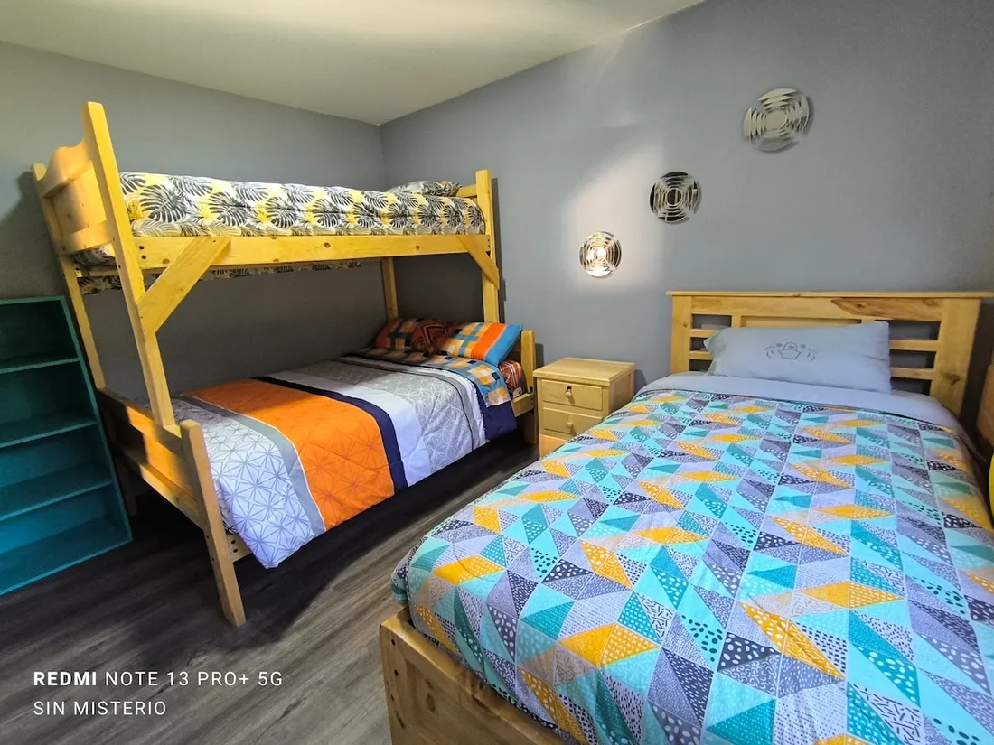 Triple room with a bunk bed and double bed at Hágale Pues