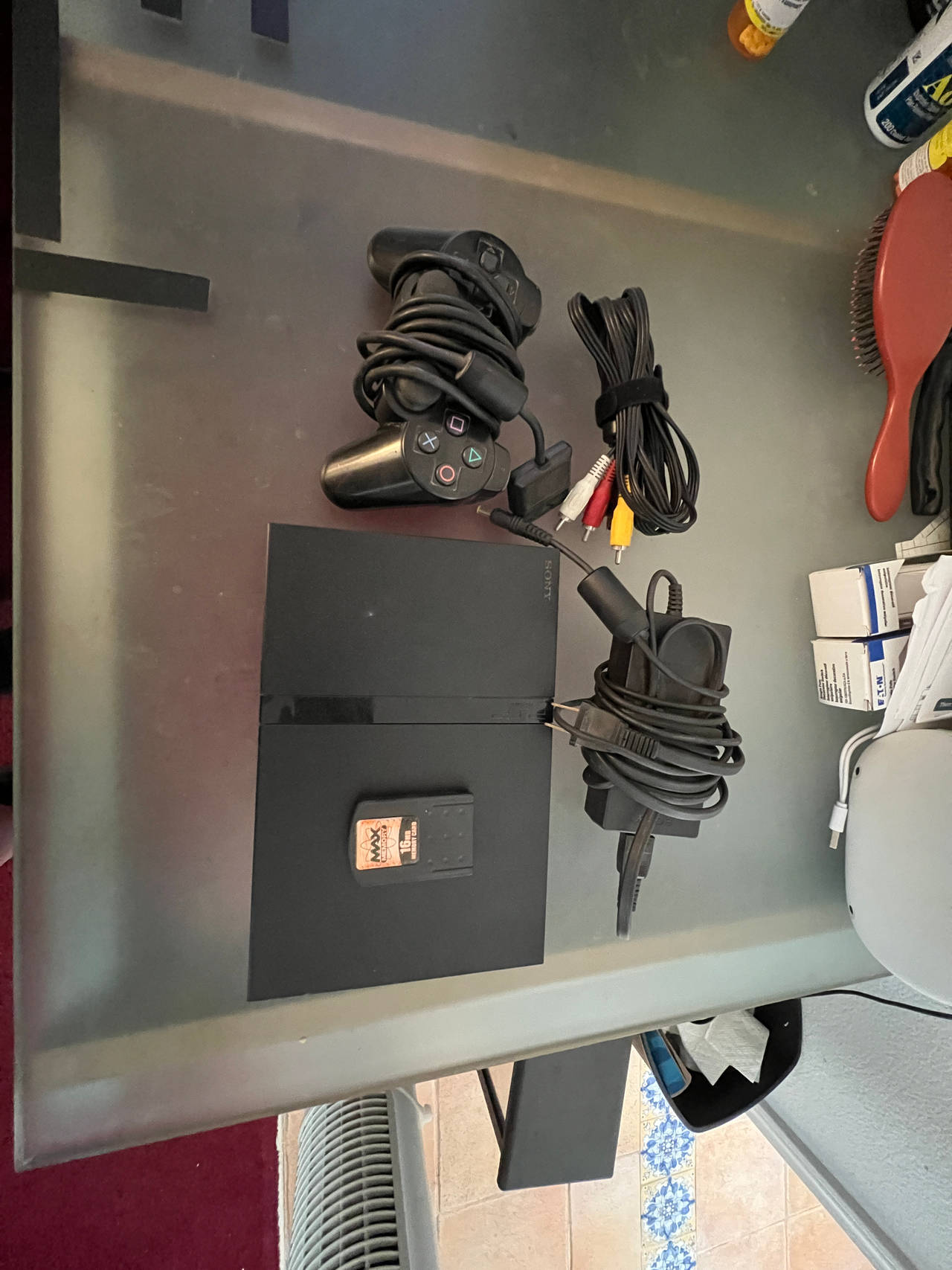 PlayStation 2 Slim with cables, controller, 16MB memory card, and some games. 