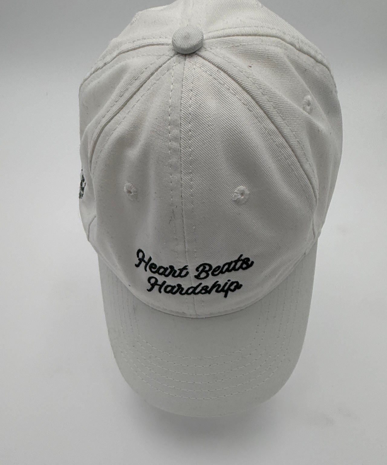 Heart Beats Hardship White Script Dad Hat