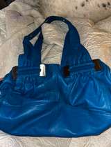 vibrant blue leather handbag, likely a shoulder bag  - Image 1