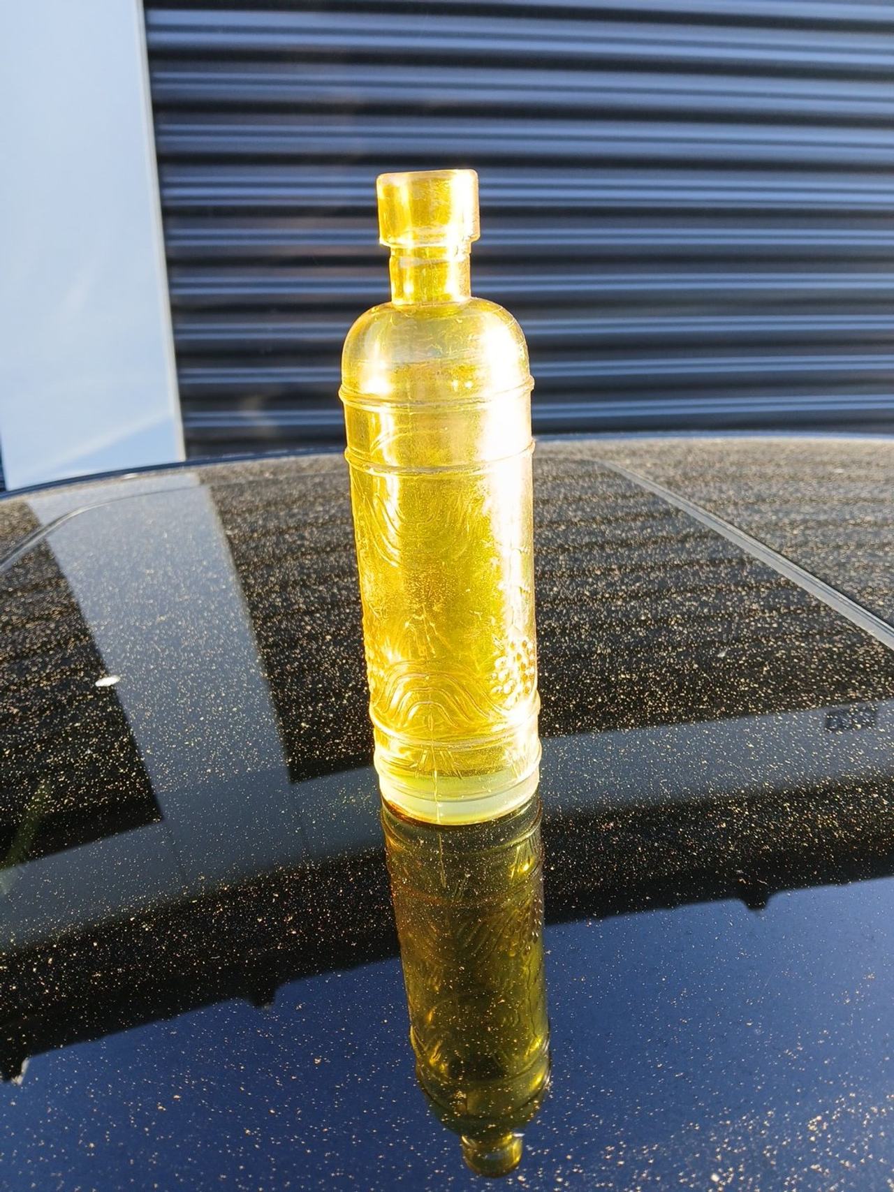 Vintage Yellow Glass Bottle with Embossed Grapes