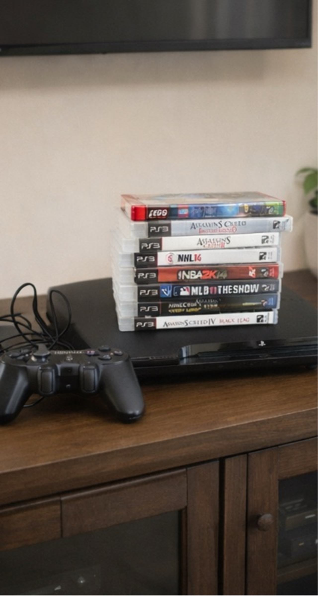 Sony PlayStation 3 Slim Black Console with one controller and games pictured