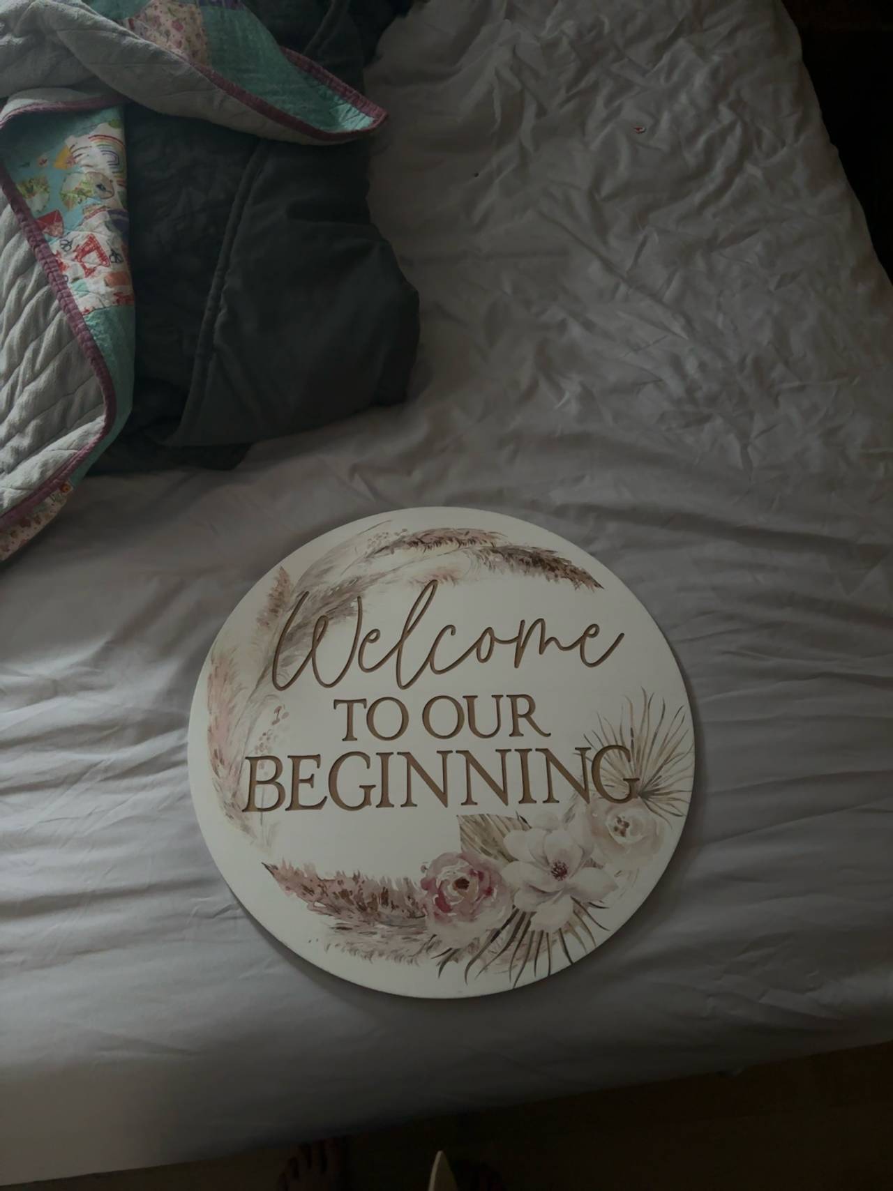 White Round Wooden Welcome to Our Beginning Sign