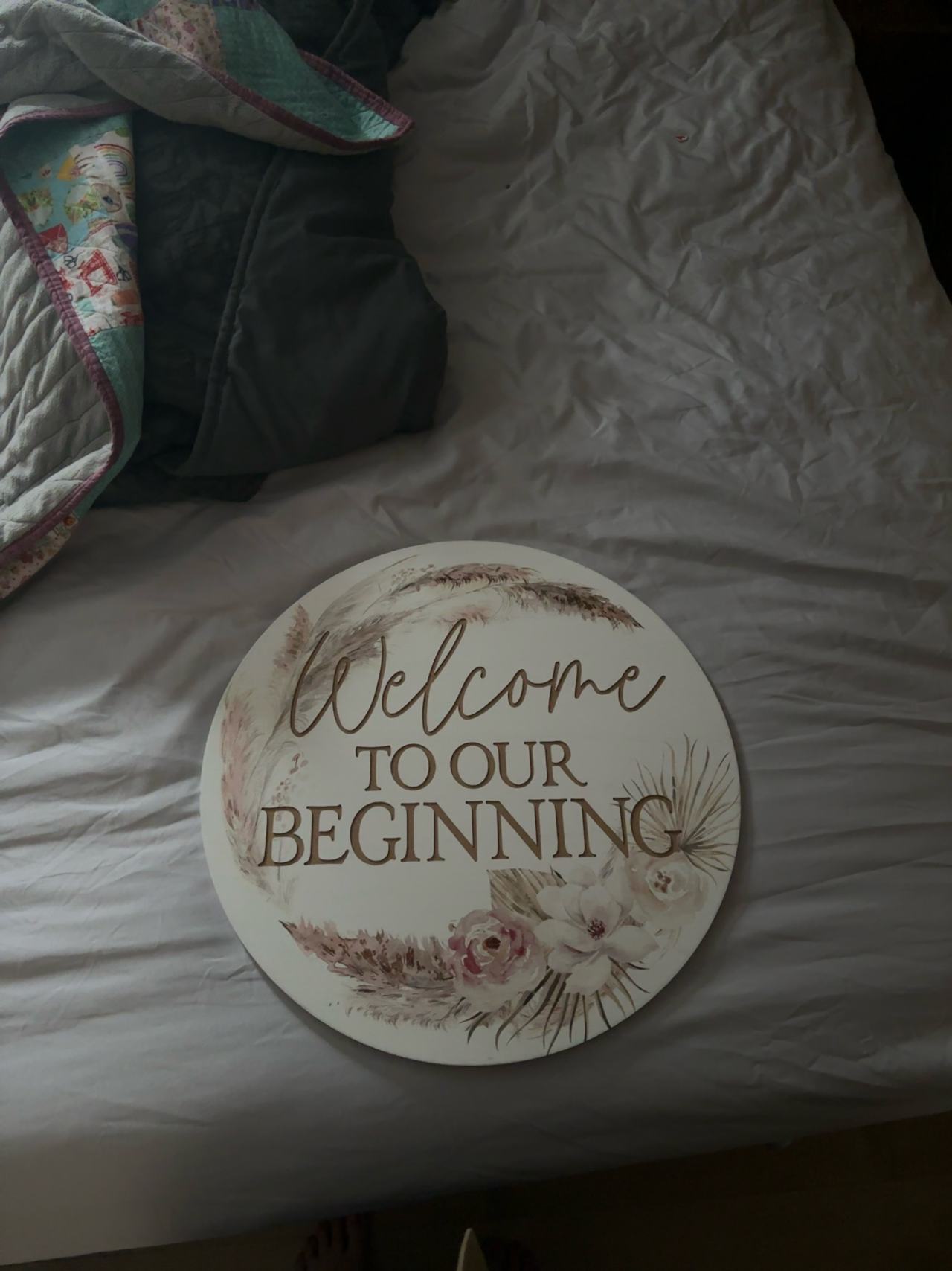 White Round Wooden Welcome to Our Beginning Sign