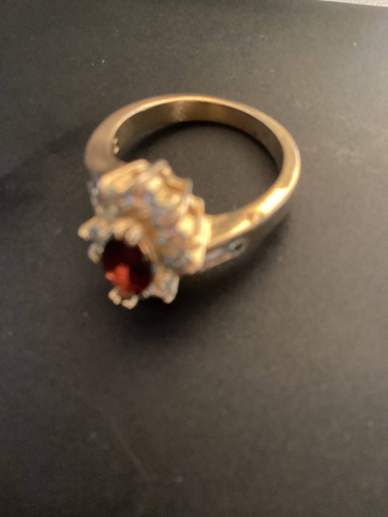 Gold Ring with Red Gemstone and Clear Stones