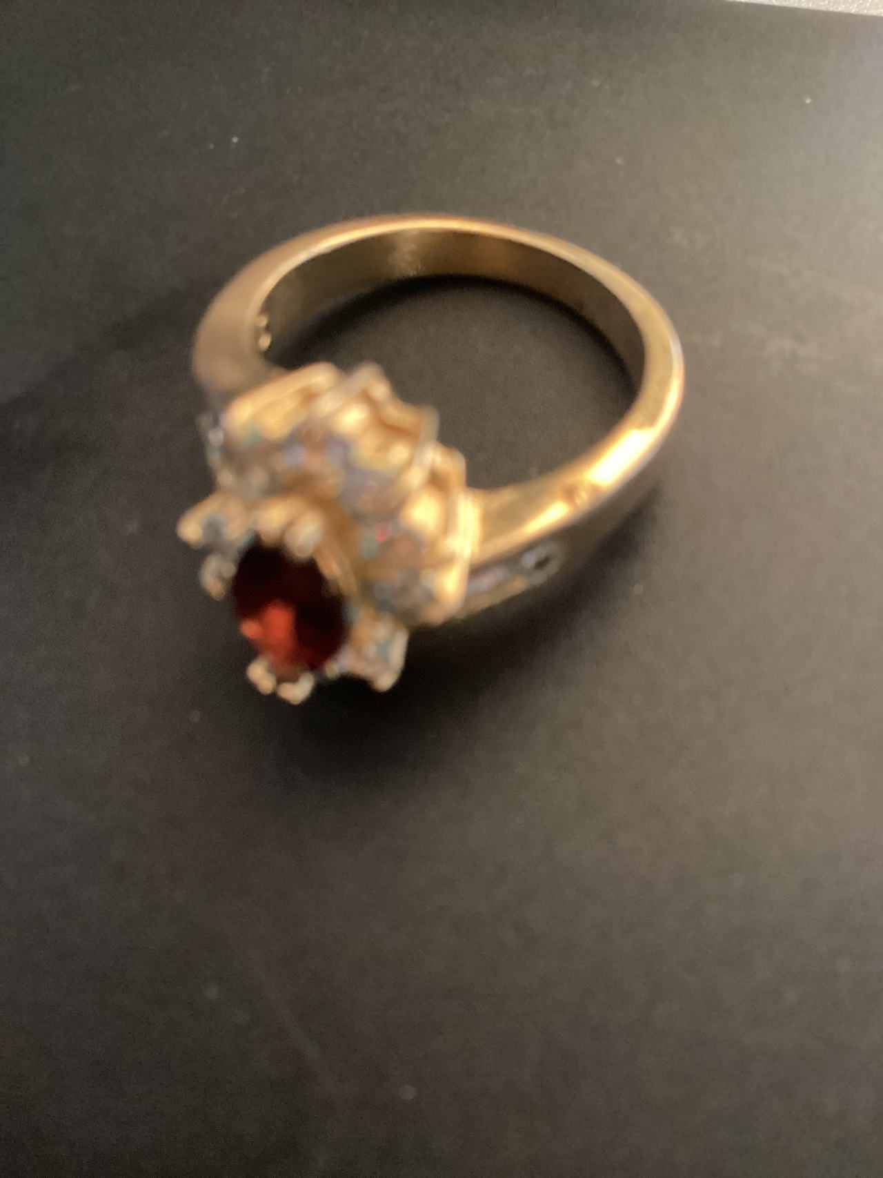 Gold Ring with Red Gemstone and Clear Stones