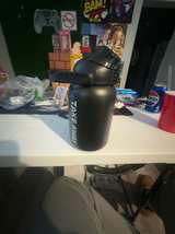 Stainless Steel Insulated Water Bottle Black Canister TAKE AWAY Lid and Hand - Image 1