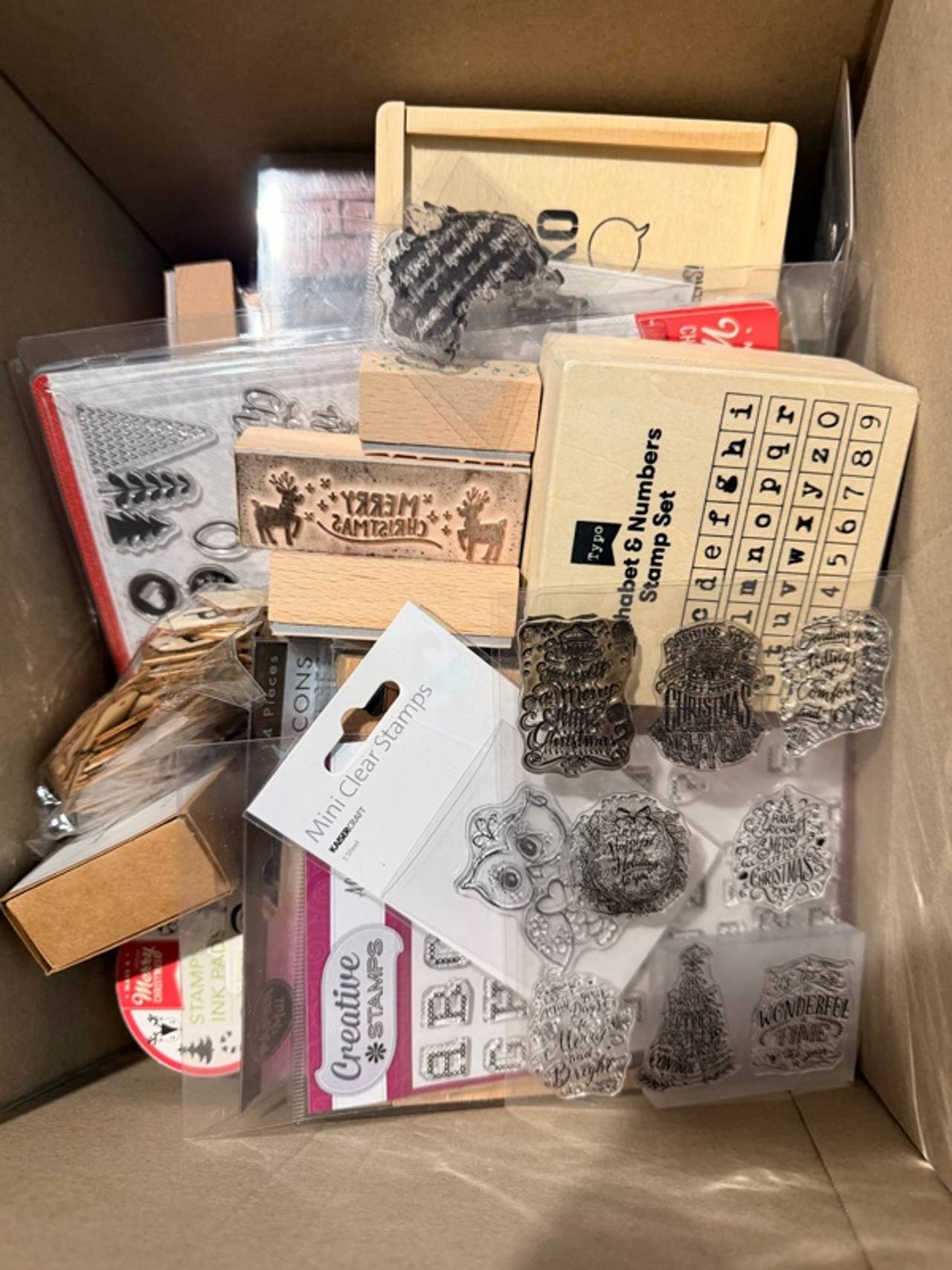 A box full of assorted craft themed wooden and block stamps. St Albans 3021