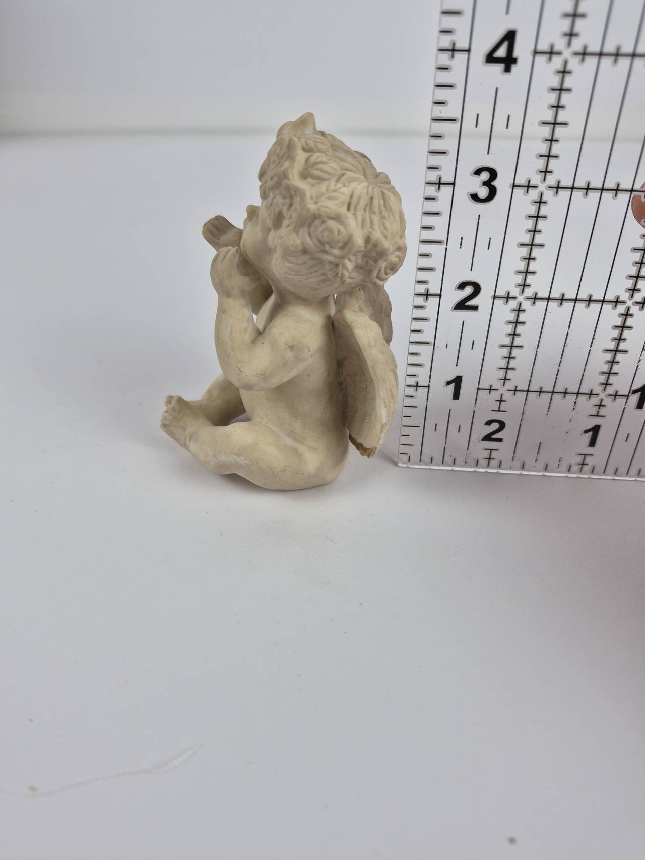 Seated Cherub Blowing a Kiss Figurine