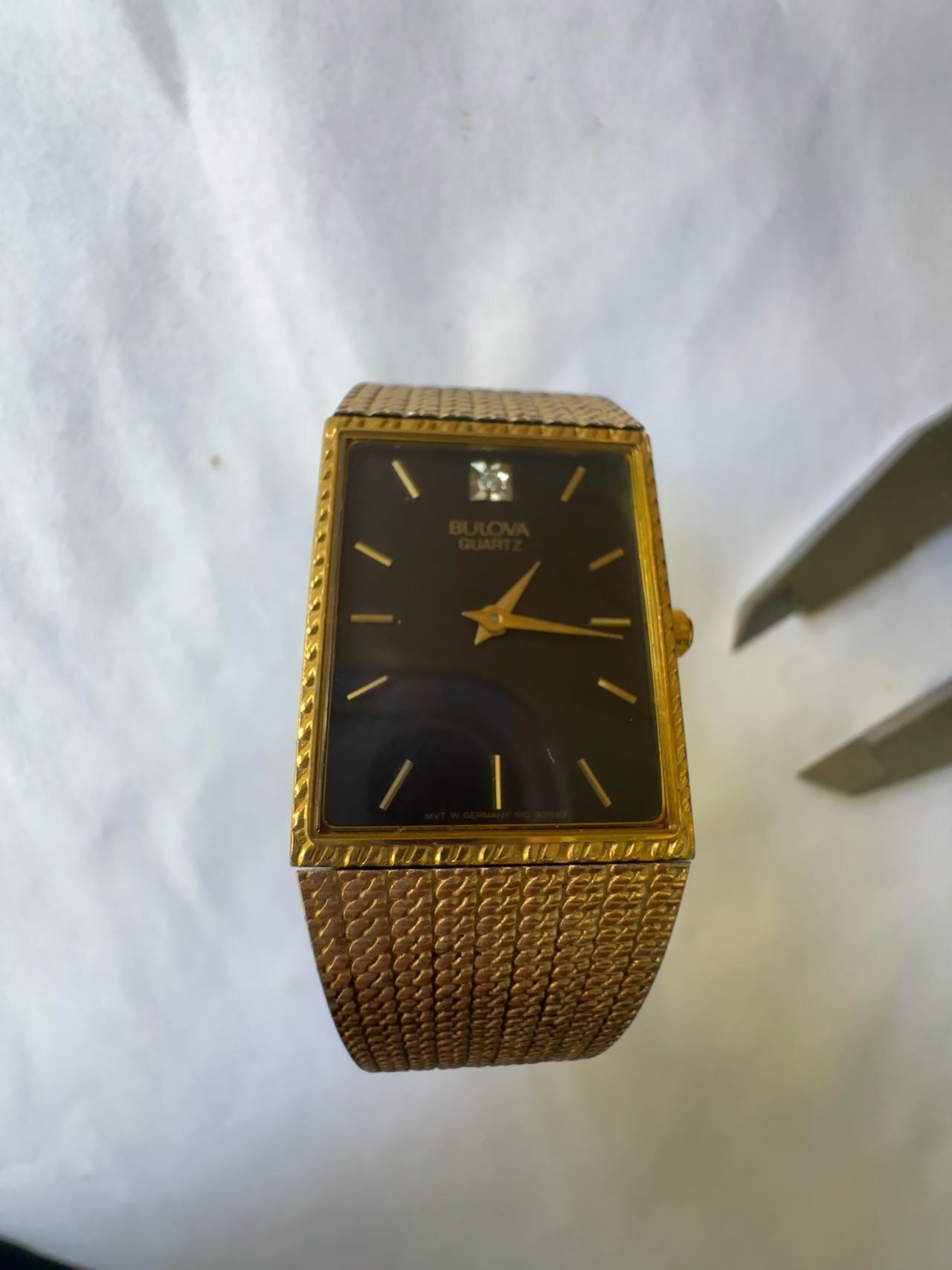 Bulova Vintage Gold Tone Tank Watch with Black Dial and Diamond Accent