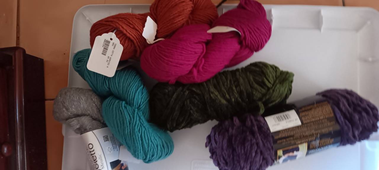 Assorted Yarn Skeins and Crafting Supplies