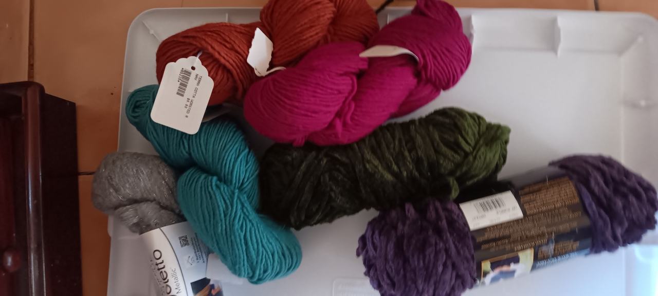Assorted Yarn Skeins and Crafting Supplies