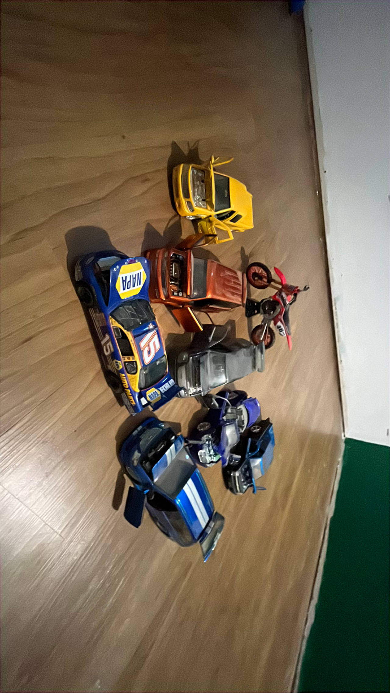 Toys cars 
All are dusty
And one of them has a crack in the windshield 