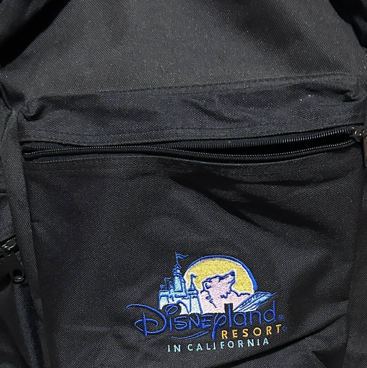 Vintage Disneyland Resort Embroidered Logo Backpack with a lot of vintage items.