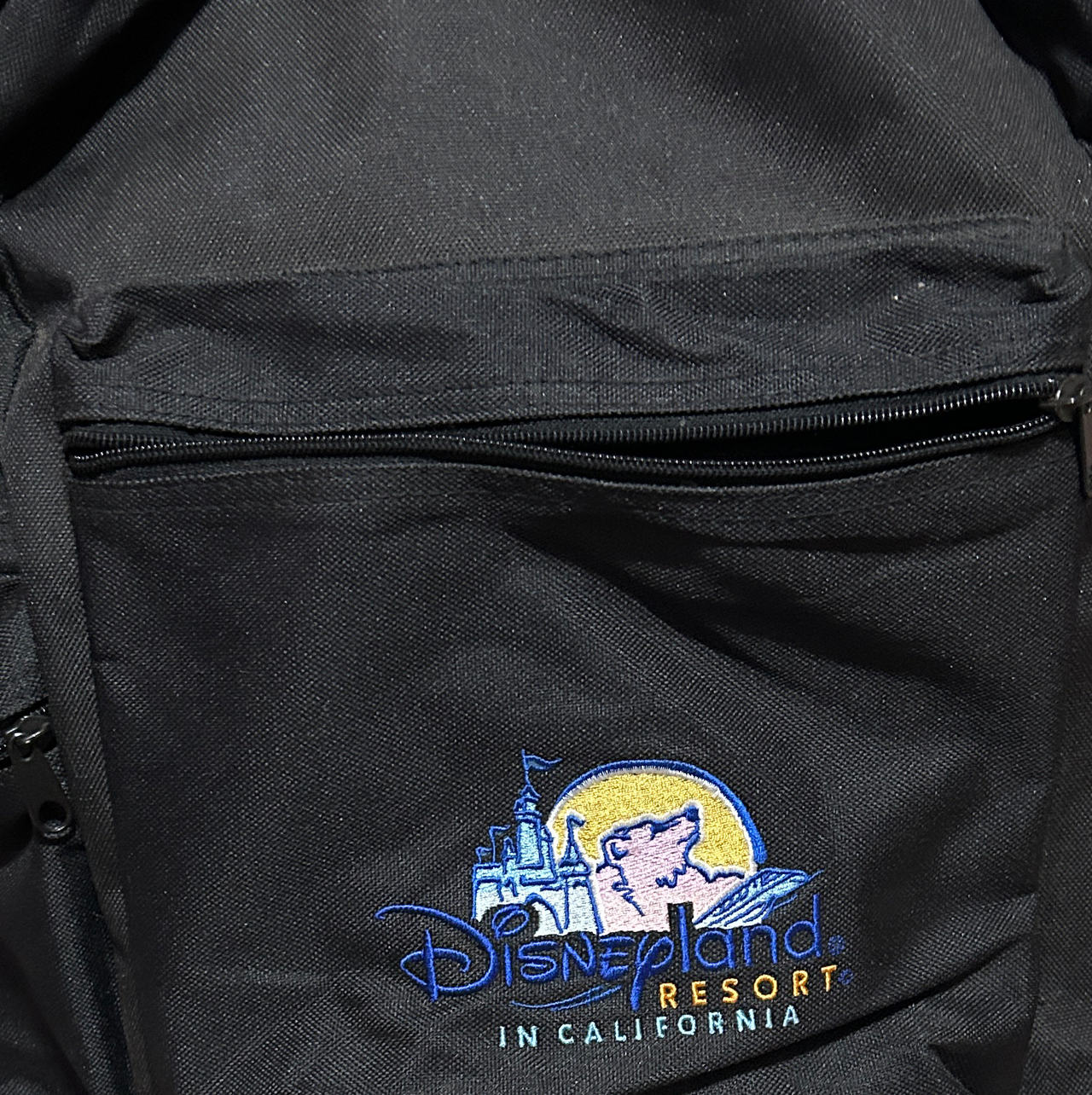 Vintage Disneyland Resort Embroidered Logo Backpack with a lot of vintage items.