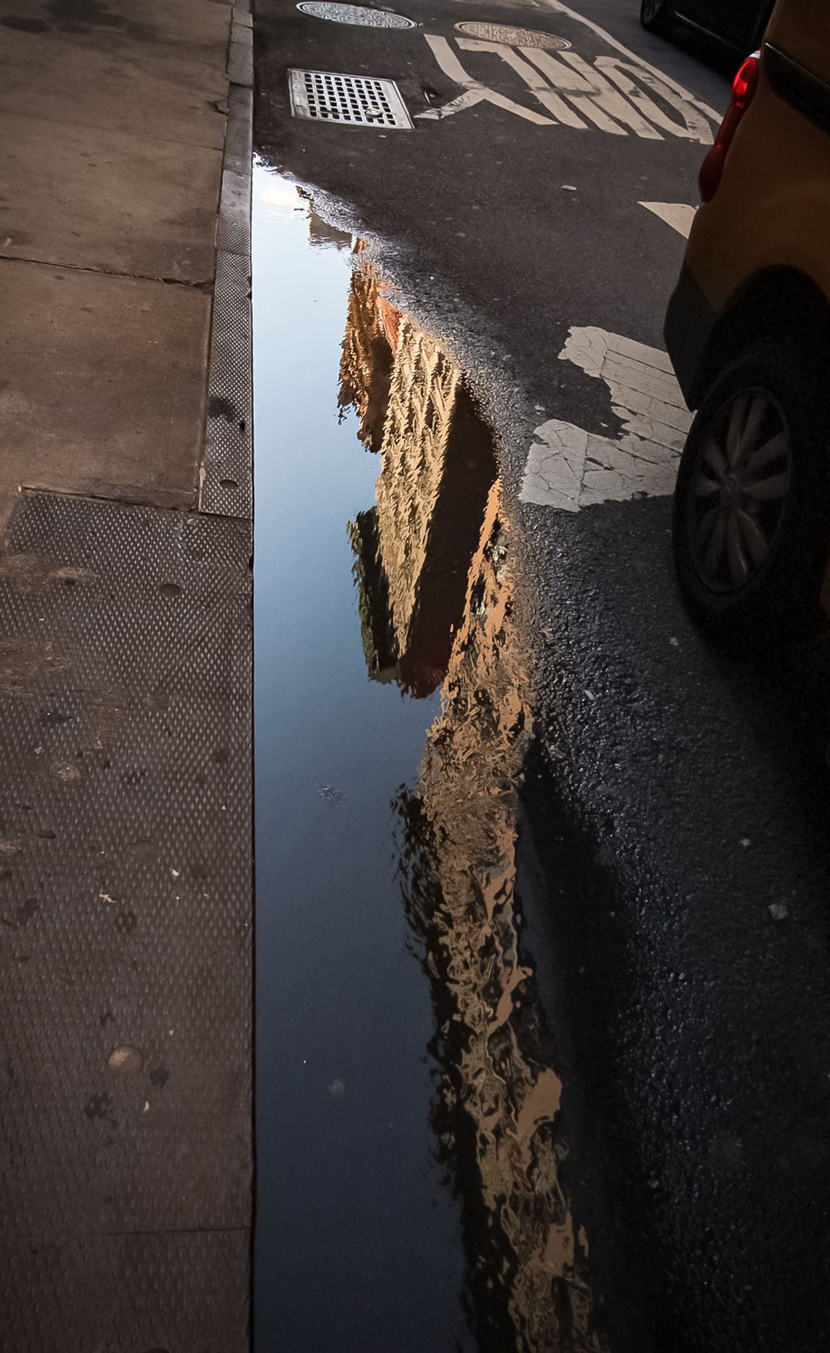 Lower Manhattan Reflection in Road Puddle