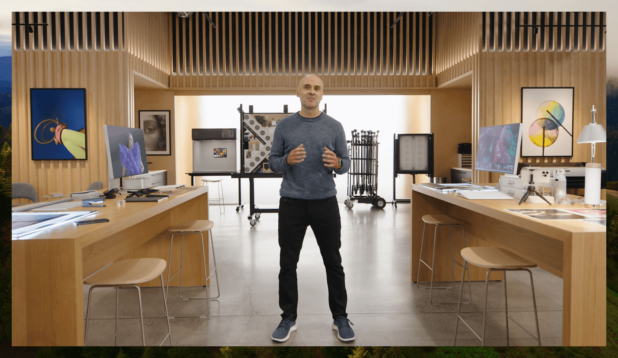 A room in Apple Park with an almost all wood design with a man presenting in the middle of it.