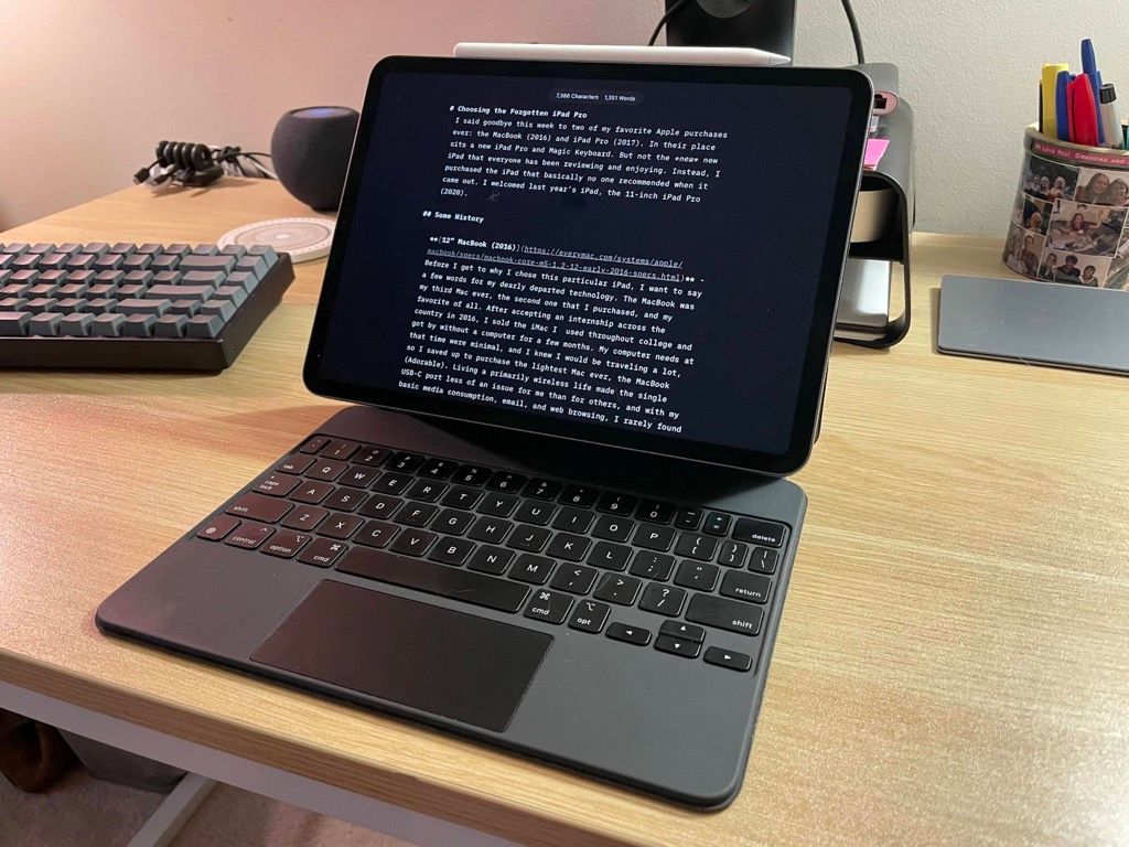 iPad and Magic Keyboard and Apple Pencil open on a table.