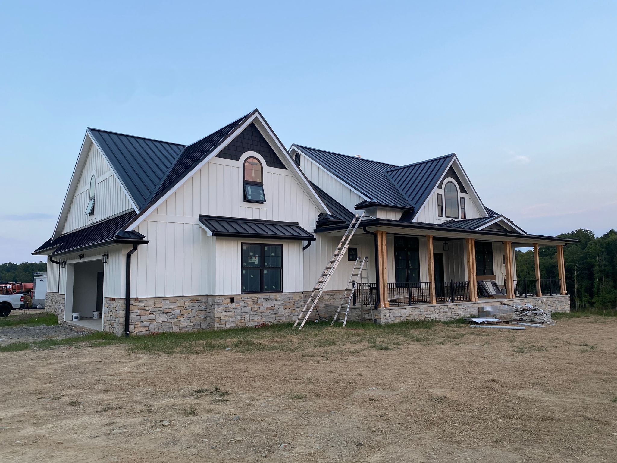 New home with black metal roof and new gutters.