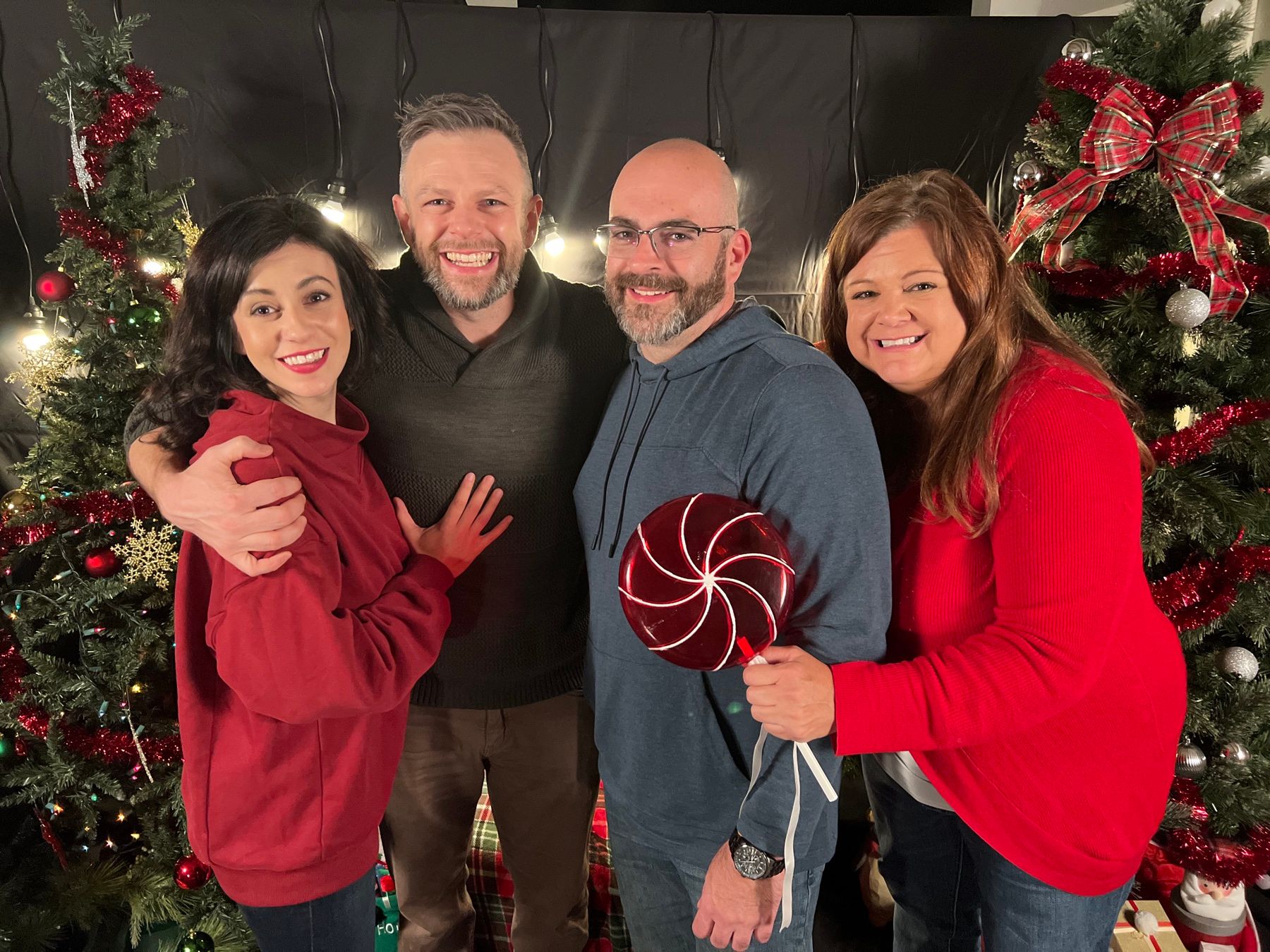 Joe with his brother and two sisters at the 40DoX kickoff party, in front of Christmas trees