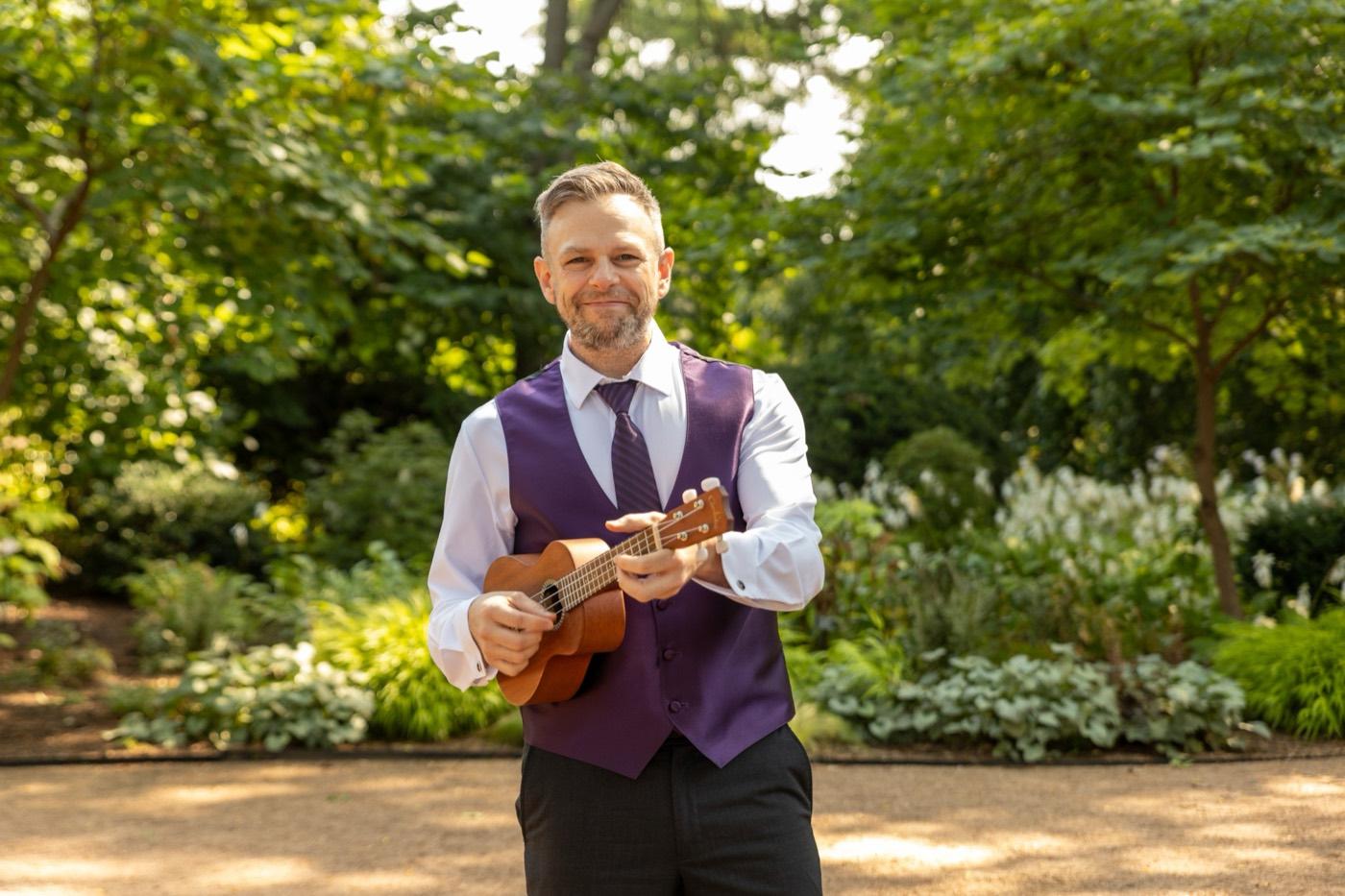Joe in a tux with a ukulele at a wedding