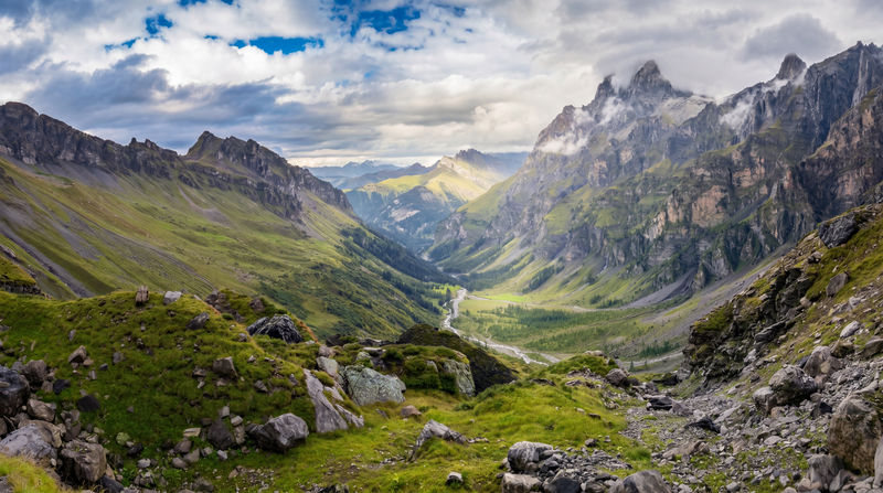 A perfect ending to the Tour des Muverans in Switzerland, the final descent of the trek unfolds through the wild and beautiful Nant Valley, while the Grand Muveran, shrouded in clouds to the right, watches over the trail.