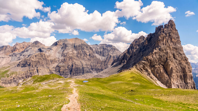 The iconic and impressive summit of Le Grand Séru, rising to 2,888 m (on the right), and the peak of Rocca Bermuda, reaching 3,222 m across the valley where the France–Italy border runs, as seen on the fifth day of the GR57 trek in the French Alps.