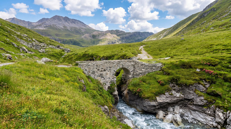 The ancient stone bridge Croé-Vie (pont de Croé-Vie), standing at an altitude of 2,099 meters above the rushing Leys stream, on the second day of the Vanoise Traverse trek (GR55).