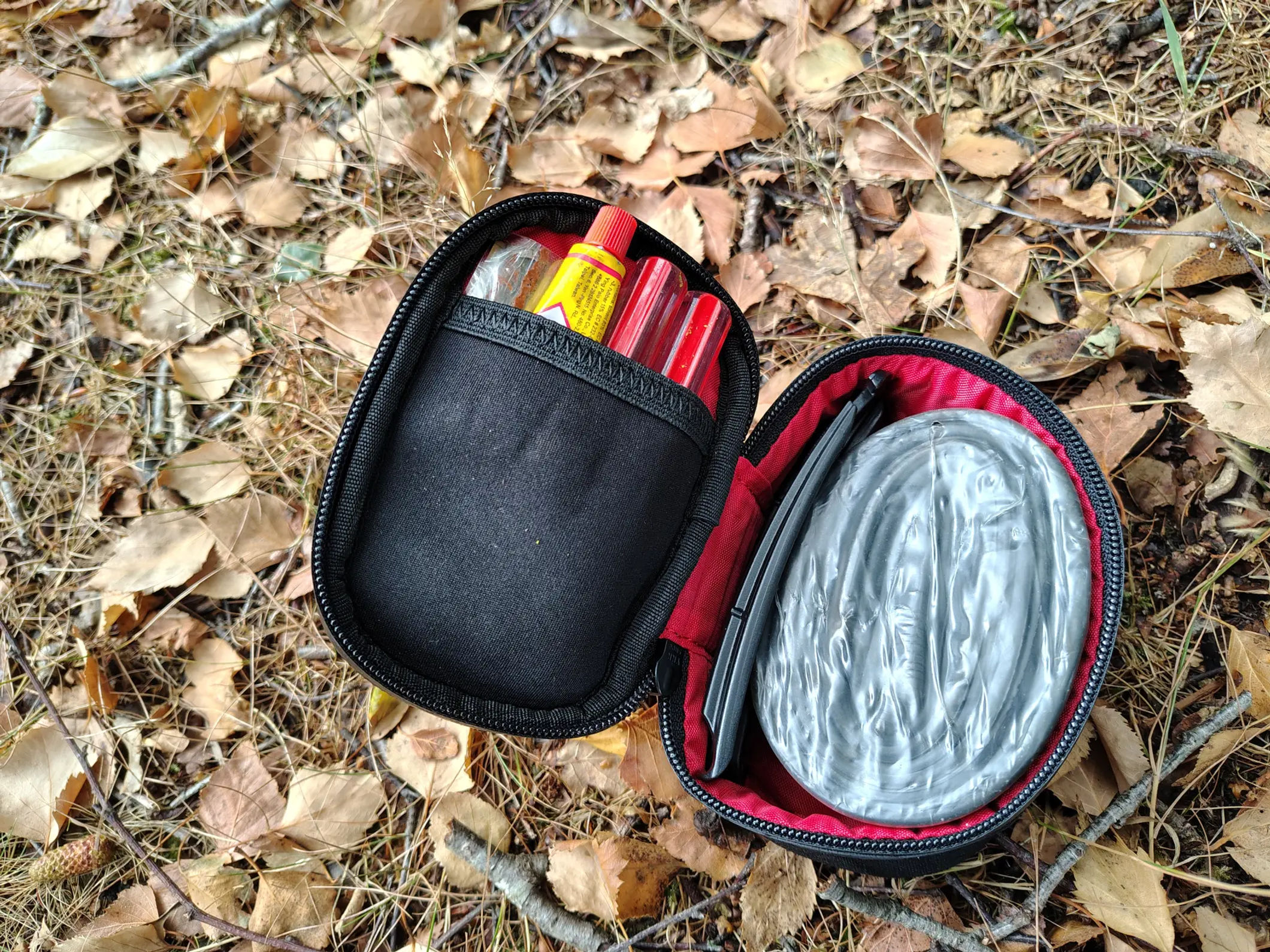 Redshift Quickdraw saddle bag opened flat on the trail showing packed TPU tube, tyre levers, and repair tools