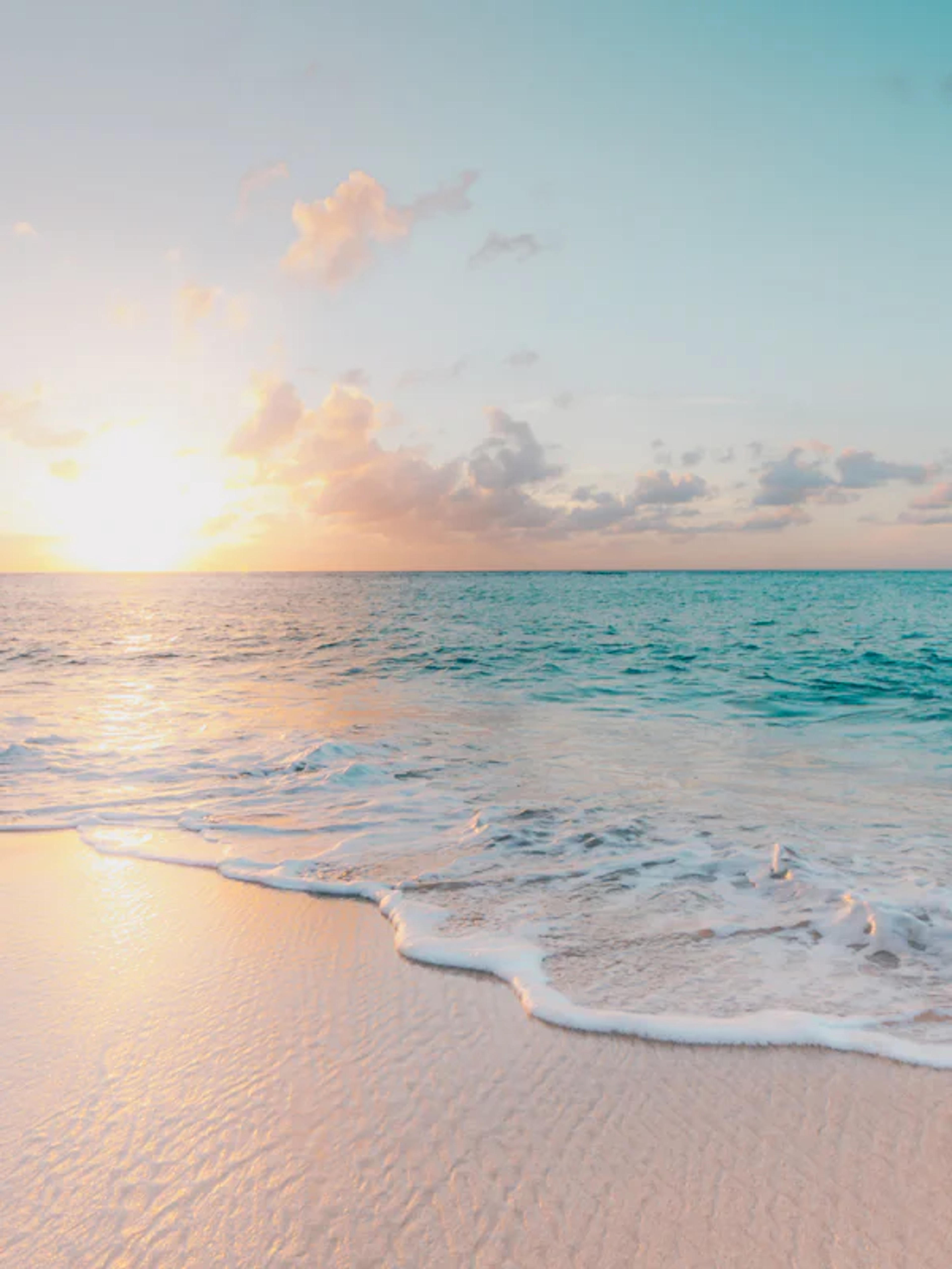 Tropical beach with gentle waves at golden hour