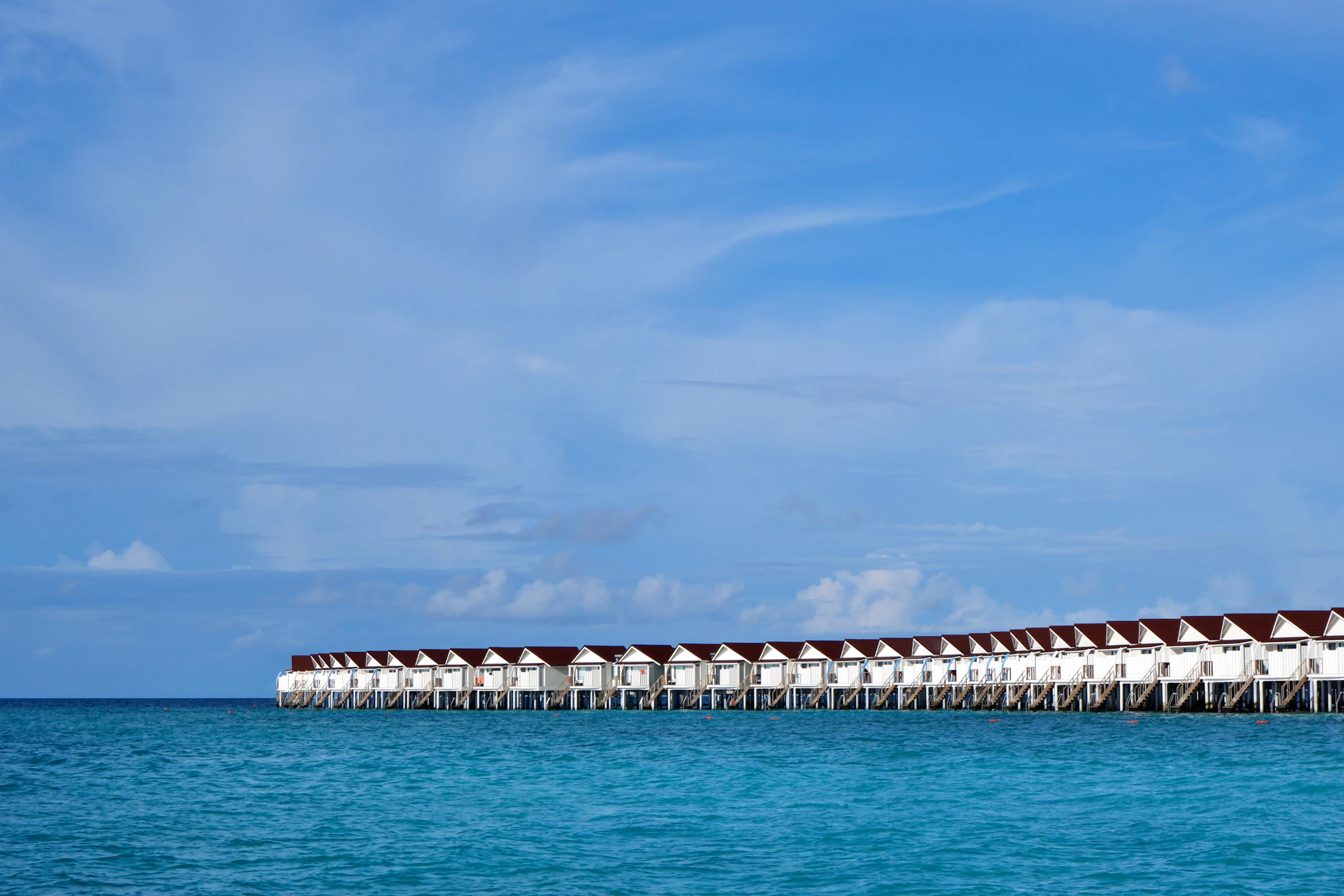 Luxury overwater bungalows in a crystal clear turquoise lagoon