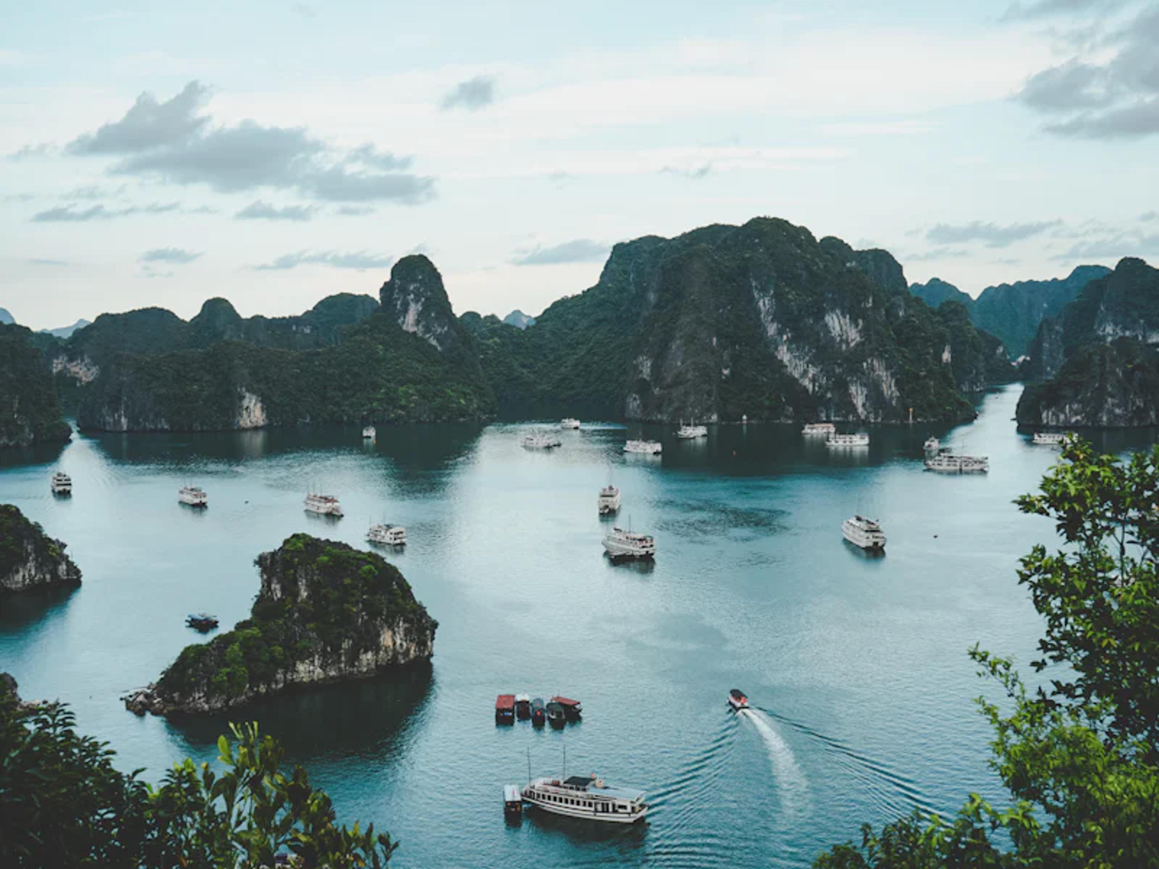 Traditional boats among limestone karsts in Ha Long Bay, Vietnam