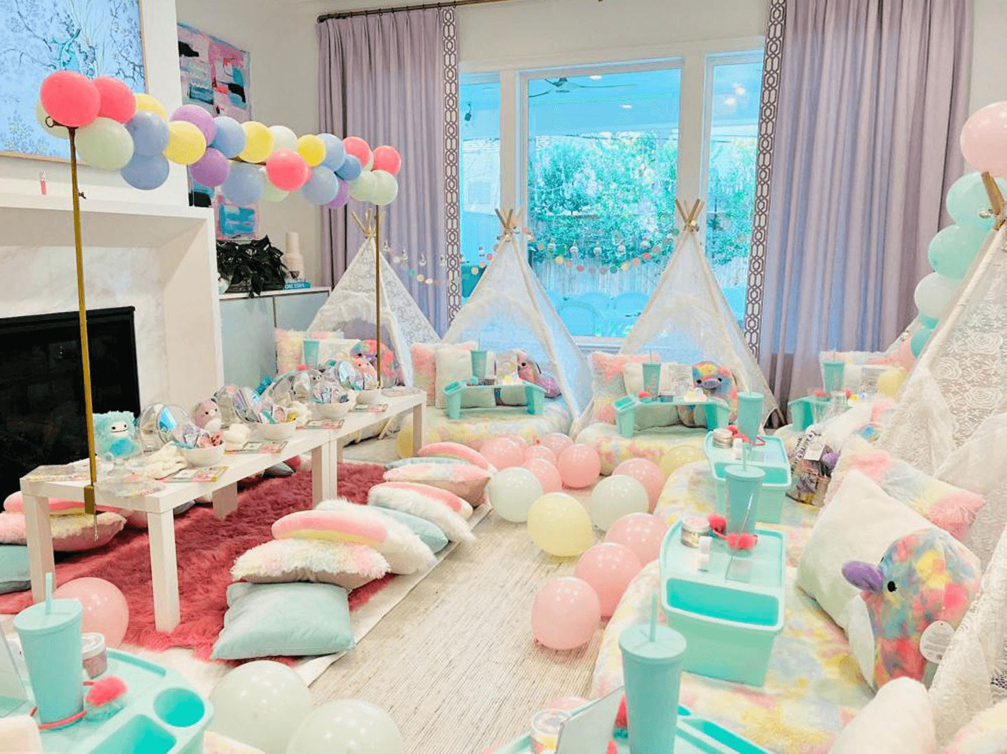 Slumber party and teepee party with a group of balloons on a bed