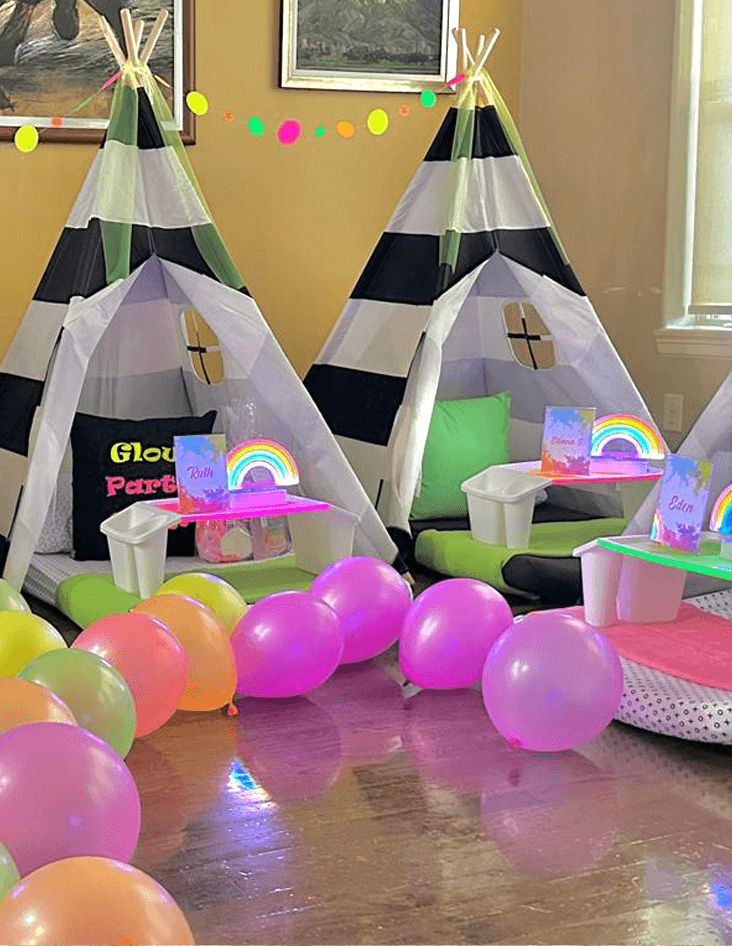 Slumber party and teepee party with a group of balloons on a bed