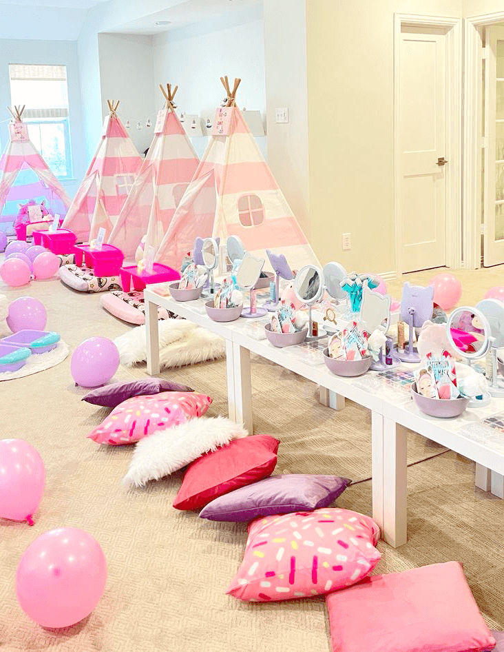 Slumber party and teepee party with a group of balloons on a bed