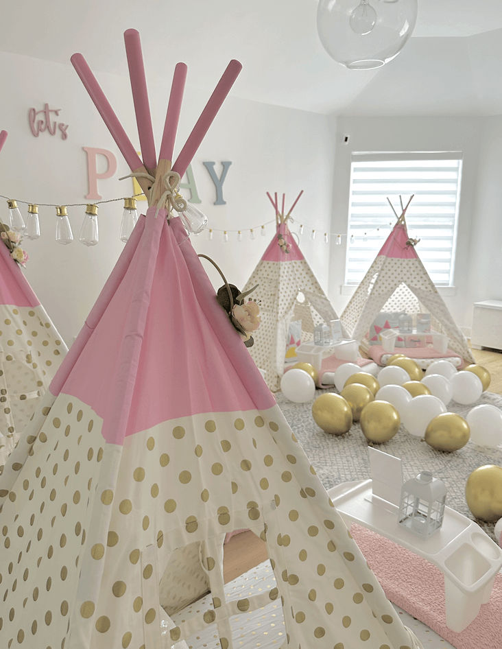 Slumber party and teepee party with a group of balloons on a bed