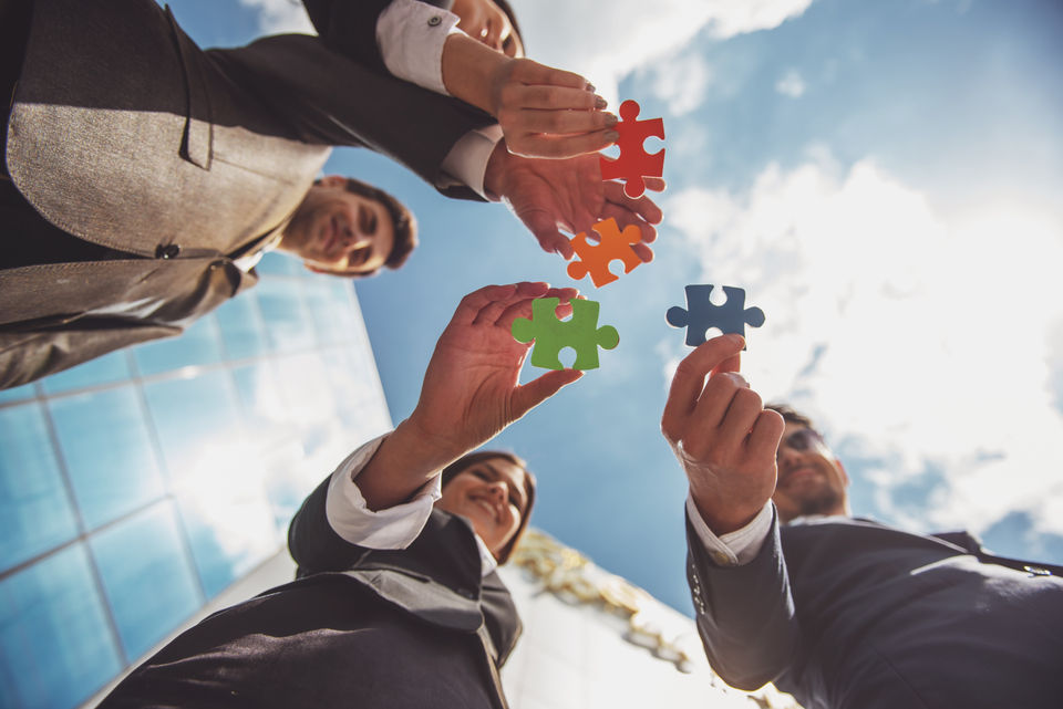 People connecting colorful puzzle pieces