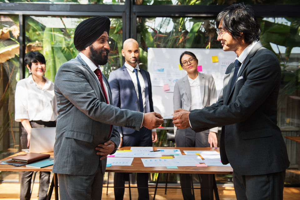 Businessmen exchanging cards during meeting