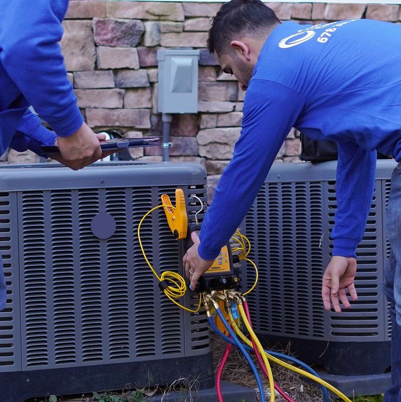 Cool United Air technicians checking an AC system