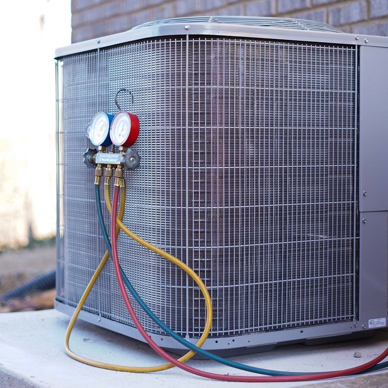 AC condenser with gauges checking pressure