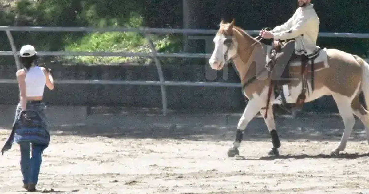 Bad Bunny on a horse and Kendall Jenner taking a picture of him