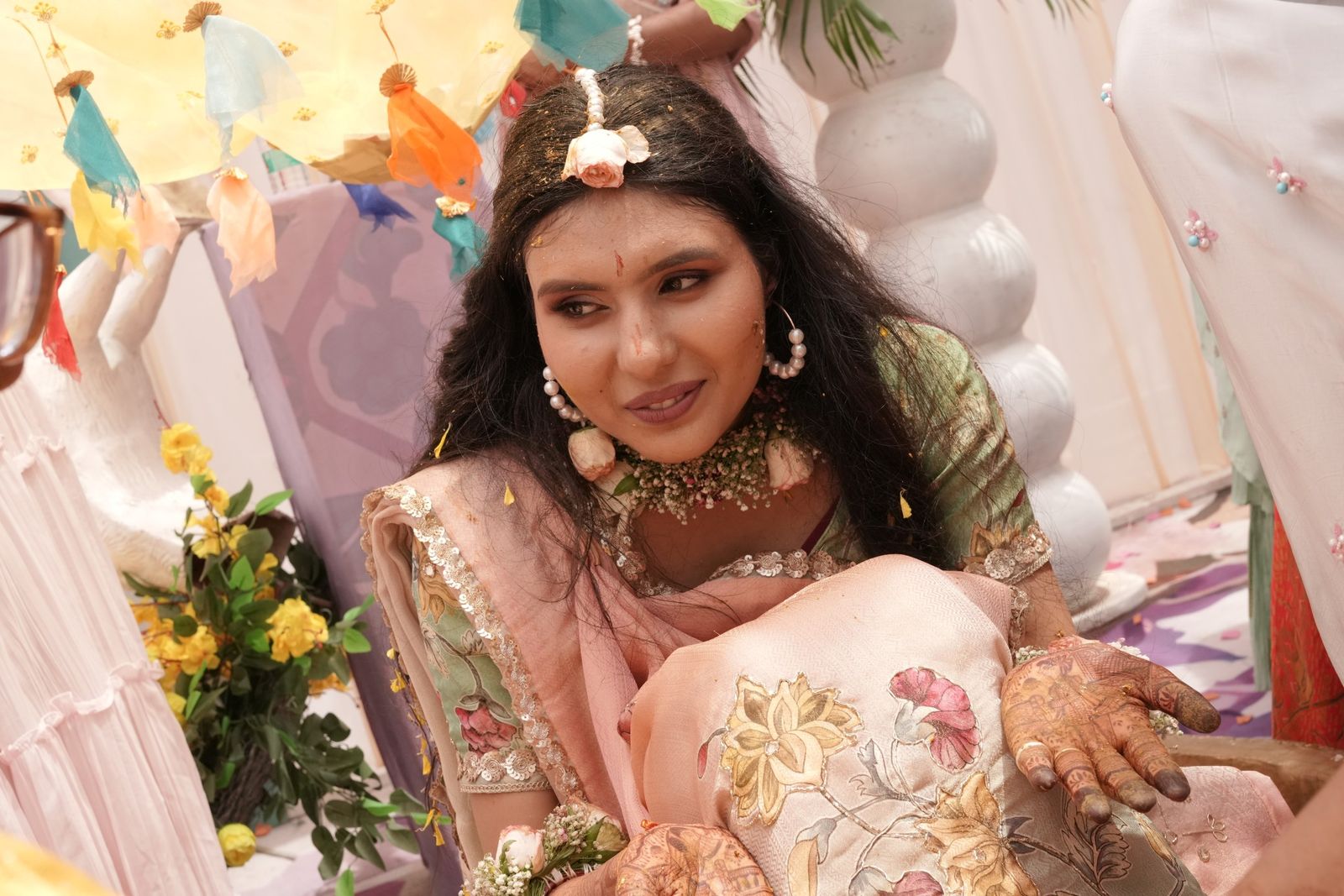 Saloni laughing through the haldi, turmeric on her cheeks