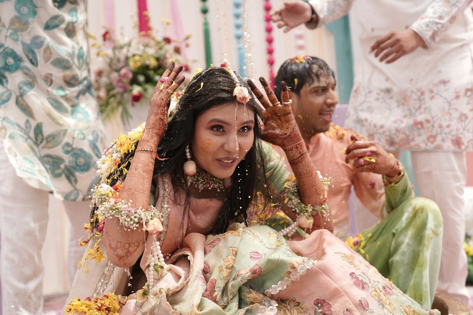 Saloni throwing her hands up as the haldi flies